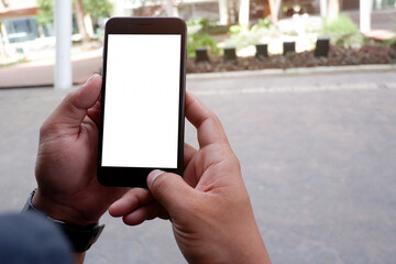 Cropped shot view of business woman’s hands holding the mobile phone with blank copy space screen for your information content or text message.