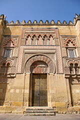 Fototapeta na wymiar Decorated door and wall of the mosque cathedral in Cordoba, Spain