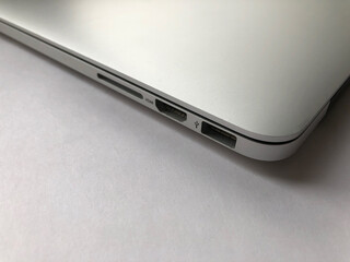 Side view on ports of the silver laptop.