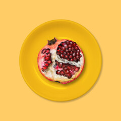 Red garnet in an orange plate. Summer style. Minimal design Art.