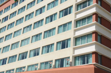 Windows of skyscrapers against a blue sky in an exotic country. Close-up. External elements. Modern office building