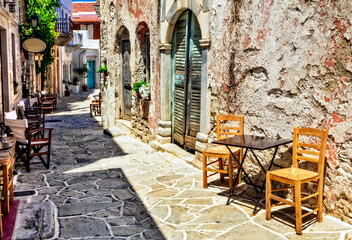 Fototapeta na wymiar Traditional Greece. Typical street cafe bars. Halki village. Naxos island, Cycades.