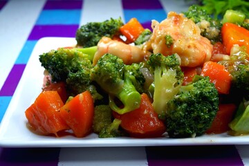 Closeup view of Broccoli stir fry with shrimp and carrot. Delicious vegetables ready to serve. 