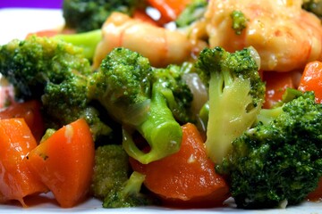 Closeup view of Broccoli stir fry with shrimp and carrot. Delicious vegetables ready to serve. 