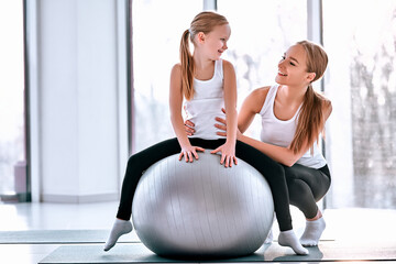 kid and mother with fitness ball