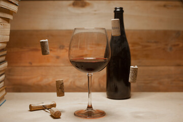 A glass of red wine with flying corks