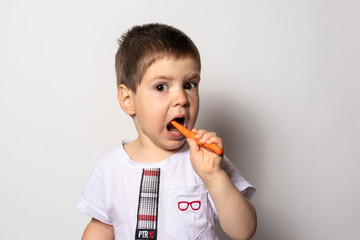 Little boy brushes his teeth with baby toothpaste. Children's toothbrush.