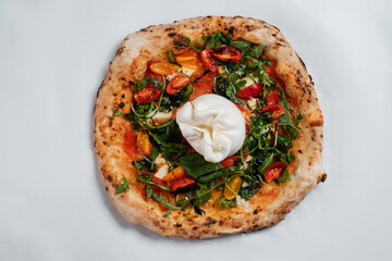 Italian pizza with tomatoes, arugula and white cheese on a white background.