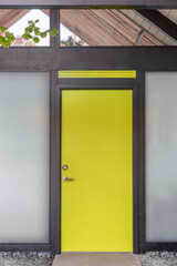 Front door, yellow front door to a mid-century modern house