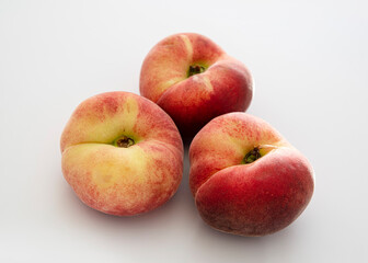 Close-up of ripe peaches on a white background