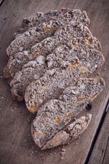 slices of rustic brown bread on a kitchen table portrait
