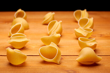 Raw uncooked pasta on the homemade wooden table