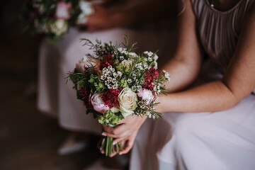 Bridesmaid holding the wedding day's beautiful bouquet of roses