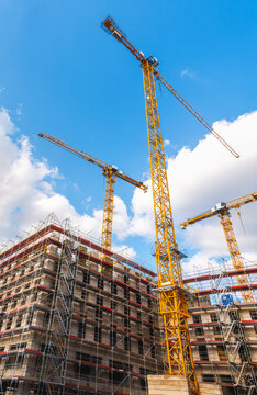 Construction site with yellow cranes