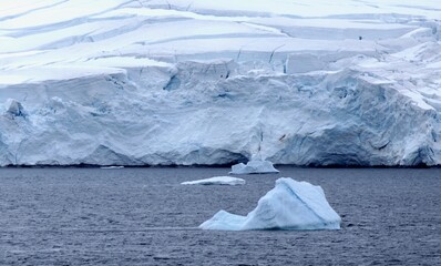Iceberg before glacier wall, Antarctica