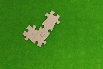 Sign jackdaws out of a cardboard puzzle on a green background. a mark, a sign of agreement.