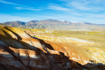 View of beautiful clay rocks, red mineral in the Kyzyl-Chin valley, Altai mountains, Russia. Autumn...