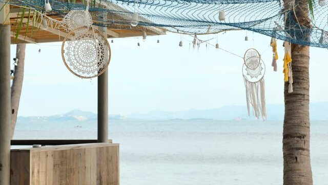 Dreamcatcher in wind at sand beach bar by the tropical island
