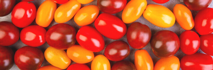 Cherry tomatoes on gray marble background. Banner.