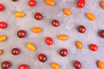 Cherry tomatoes on gray marble background.
