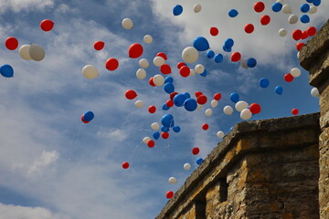 Balloons fly in the sky above the fortress