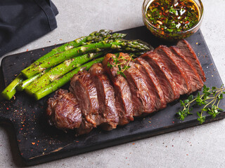 juicy roasted beef chopped steak, mutton with asparagus, close up, sauce