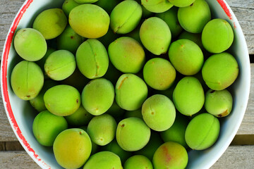 Bowl of green ume Japanese apricot plum fruit