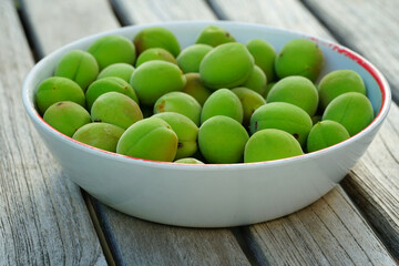 Bowl of green ume Japanese apricot plum fruit