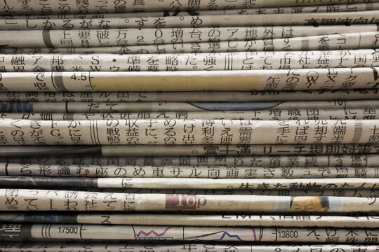 Close up of stack of Japanese newspapers