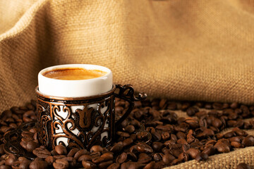 Turkish coffee. Copper cup with traditional oriental patterns of demitasse, oriental sweets rahat lokum