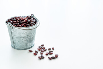 harvesting red beans. red beans in a small metal bucket. free space for text