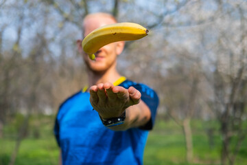 Fiy happy male with banana in hands