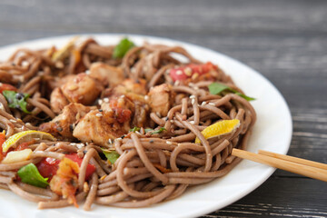 Japanese buckwheat noodle soba with vegetables, chicken meat and soy sauce. Healthy japanese menu. selective focus. asian food.