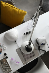 Professional equipment for manicure on table in beauty salon, top view