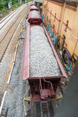 Fototapeta na wymiar Cargo train with aggregate stones, view from above