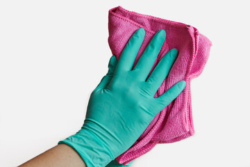 Hand with glove and cleaning cloth cleans white surface