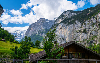 Fototapeta na wymiar Amazing touristic alpine village with famous church and Staubbach waterfall, Lauterbrunnen, Switzerland, Europe