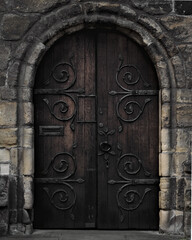 Close up of wrought iron on wooden door of church