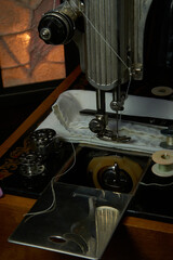 Sewing machine and parts on a dark background.