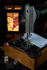 Sewing machine and parts on a dark background.