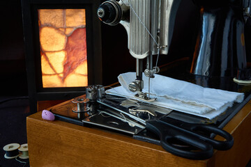 Sewing machine and parts on a dark background.