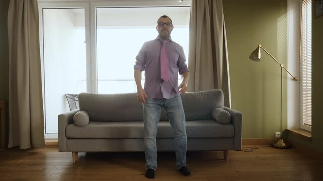 Man Dancing at Home Living Room, Fun Celebrating Funny Viral Dance Freedom Weekend. Happy Young Guy Enjoying Shuffle Dance, Having Fun Party. Joyful Man Dancing Cheerful In Living Room. Happy People.