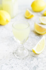 Italian traditional liqueur limoncello with lemon