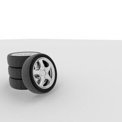 image of a stack of car wheels on a gray background.