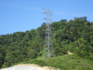 SEREMBAN, MALAYSIA -JUNE 18, 2019: High tension galvanized iron pylon tower transmitting high voltage electrical power to the consumer. 