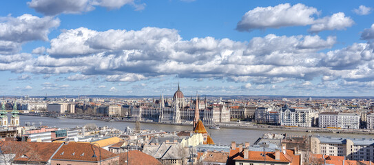 Cumulostratus clouds over Hungarian Parliament by Danube river in Budapest winter morning