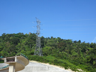 SEREMBAN, MALAYSIA -JUNE 18, 2019: High tension galvanized iron pylon tower transmitting high voltage electrical power to the consumer. 