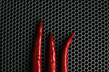 spicy red chilli close-up top against a dark background 