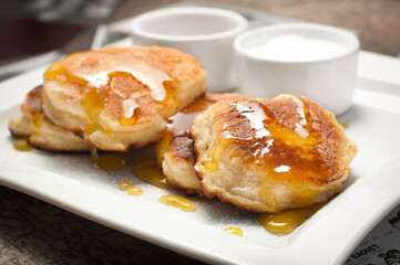 The idea of breakfast. pancake with syrup and honey.