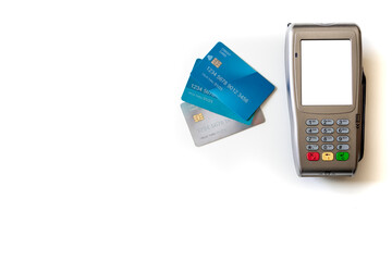 payment terminal and credit cards on white background.